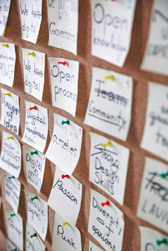 Colorful sticky notes pinned to a cork board for strategic planning and idea collection.