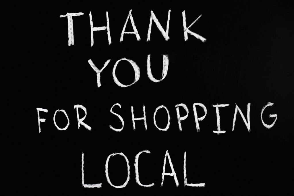 A chalkboard with handwritten message thanking for supporting local businesses.